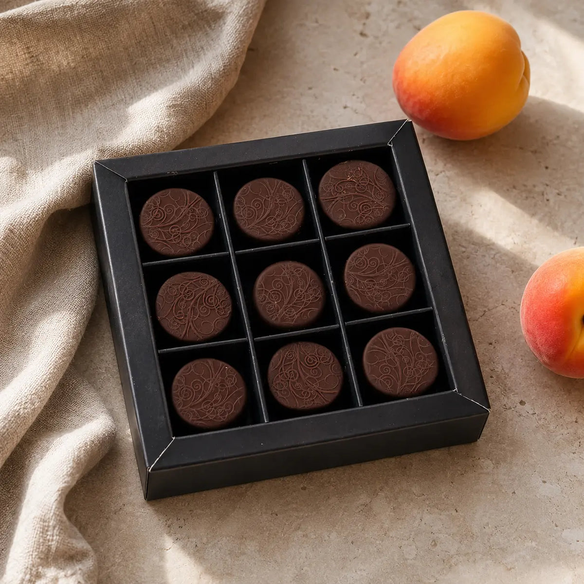 Neun Aprikosen Pralinen von Jungermann Gourmet in einer schwarzen Pralinenschachtel