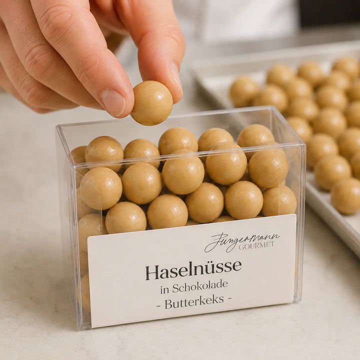 Haselnüsse in Schokolade Butterkeks beim Einfüllen in die Originalbox