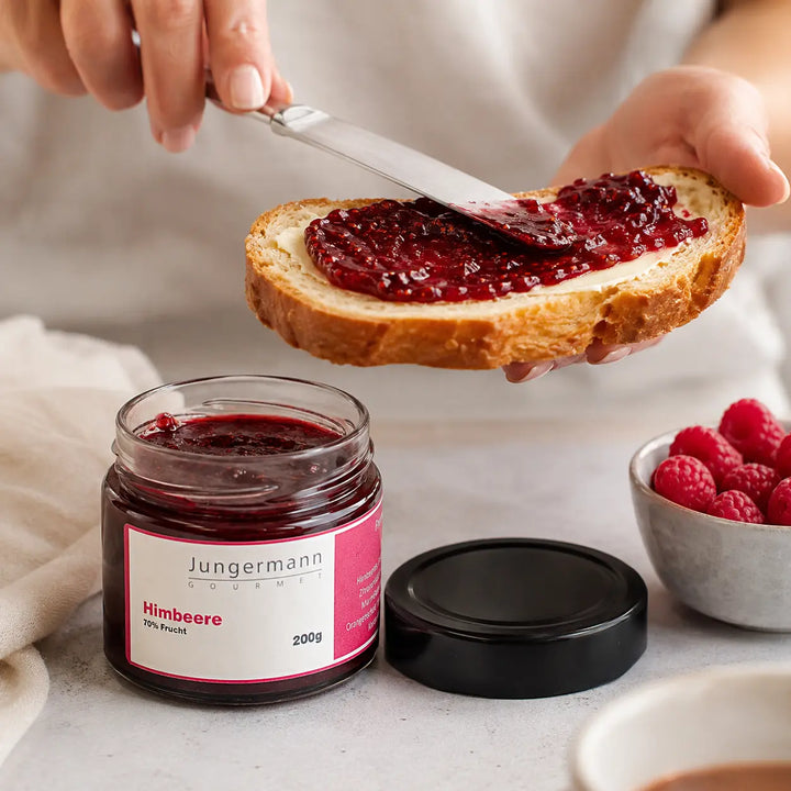 Himbeer Aufstrich beim Streichen auf gebutterte Brioche