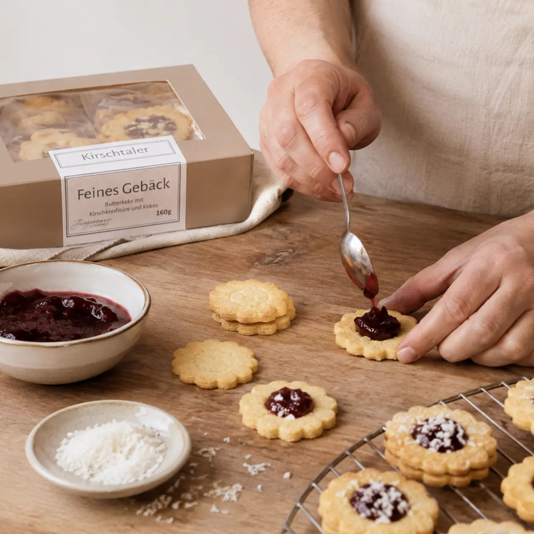 Kirschtaler bei der handwerklichen Zubereitung mit Kirschkonfitüre und Kokos