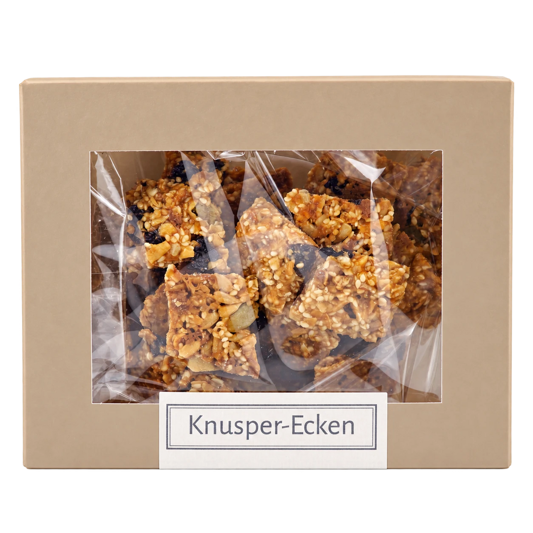 Knusper-Ecken von Jungermann Gourmet in der Gebäckschachtel mit Sichtfenster – freigestellte Frontalansicht.