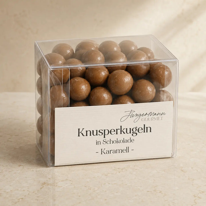 Karamell-Knusperkugeln in Schokolade in der originalen transparenten Jungermann-Gourmet-Box