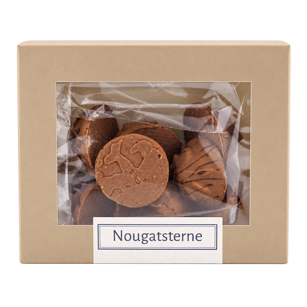 Nougatsterne von Jungermann Gourmet in der Gebäckschachtel mit Sichtfenster – freigestellte Frontalansicht.