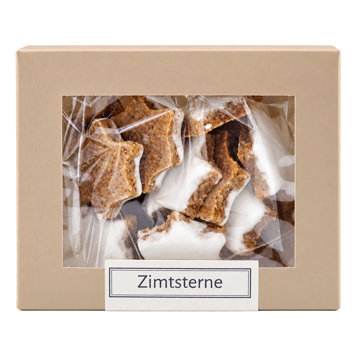 Zimtsterne von Jungermann Gourmet in der Gebäckschachtel mit Sichtfenster – freigestellte Frontalansicht.
