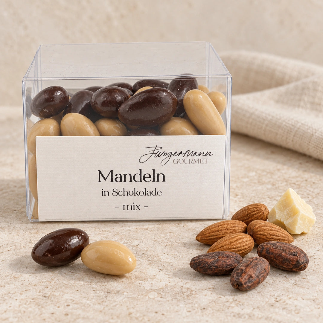 Mandeln in Schokolade Mix von Jungermann Gourmet in der transparenten Originalbox mit Mandelkernen, Kakaobohnen, Kakaobutter und zwei ganzen Schokoladenmandeln
