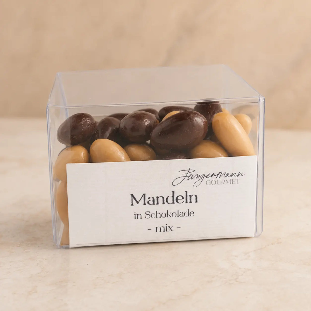 Mandeln in Schokolade Mix in der originalen Klarsichtbox als Packshot